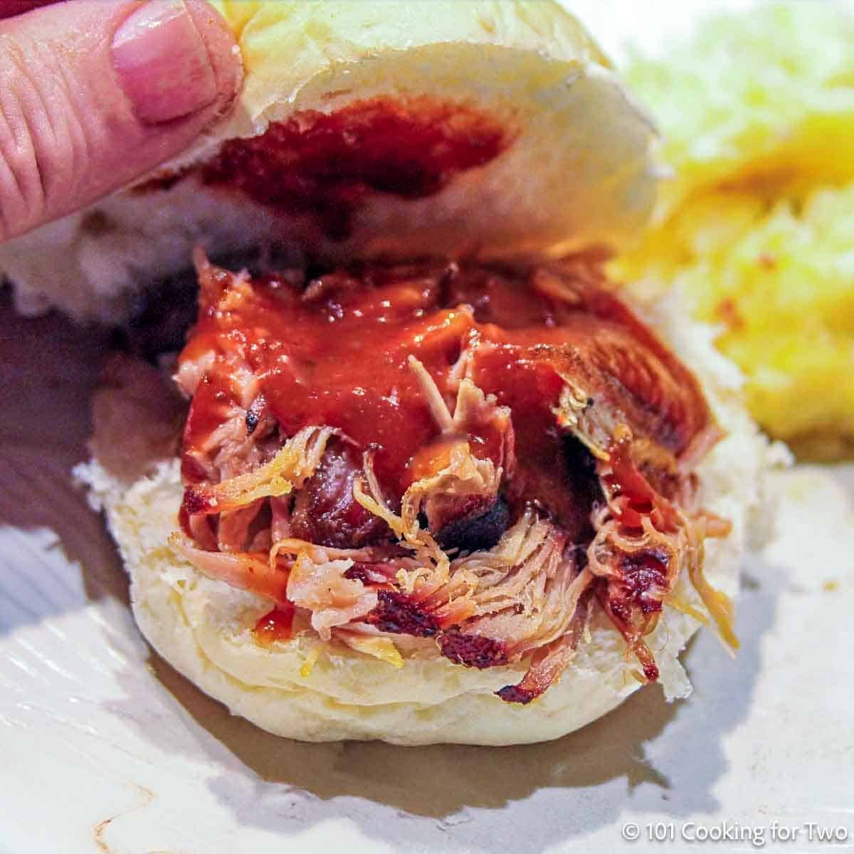 Oven pulled pork sandwich with sauce.