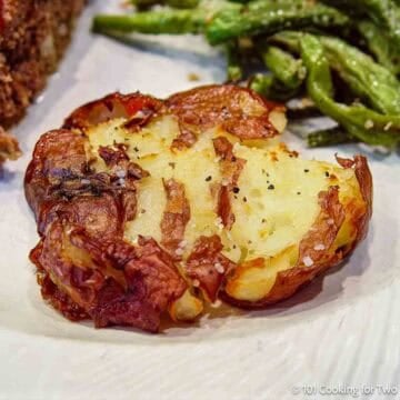 A smashed potato with beans.