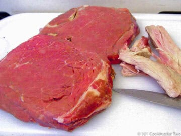 Trimming fat from sirlion steak.