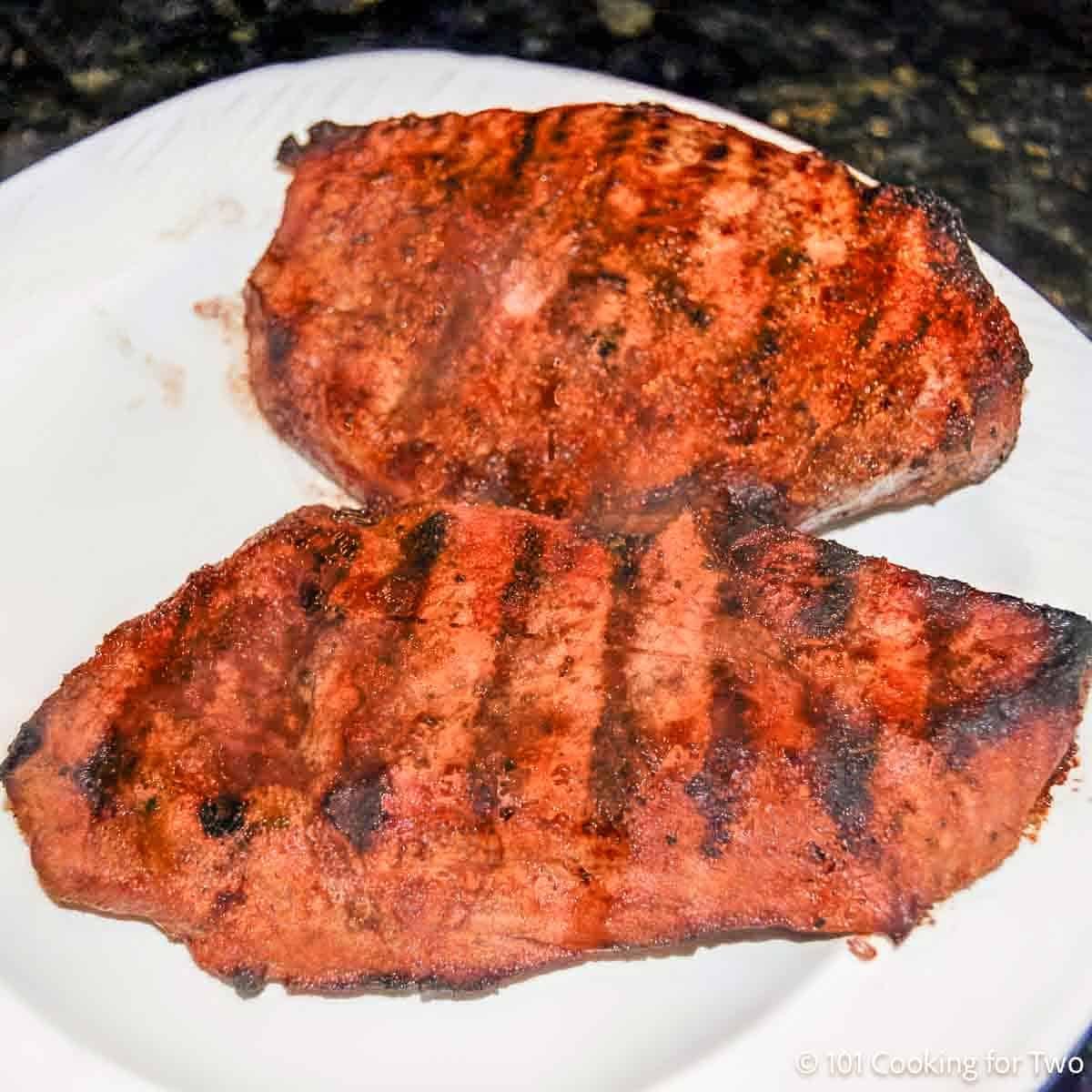 Two grilled sirloins on a plate.