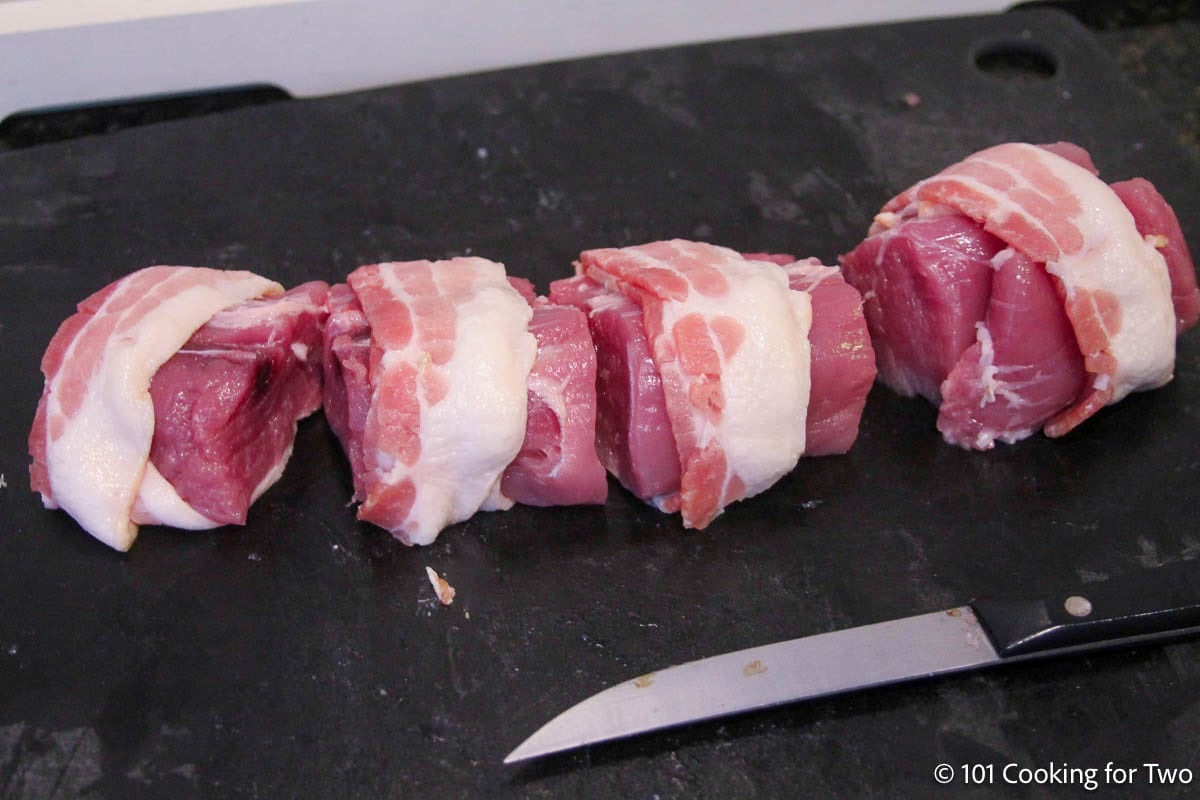 Wrapping the pork pieces with the bacon