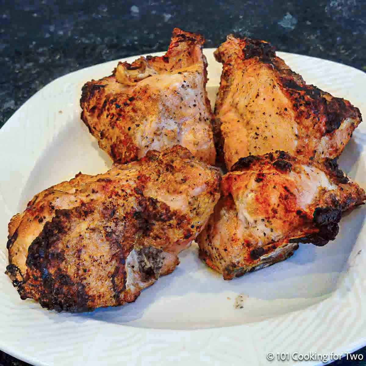 Grilled split chicken on a plate.