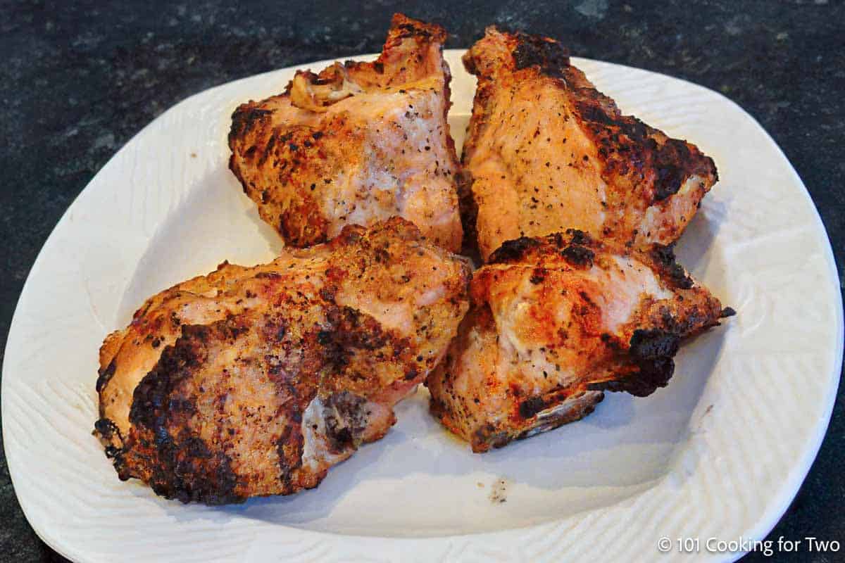 Grilled split chicken on a plate.