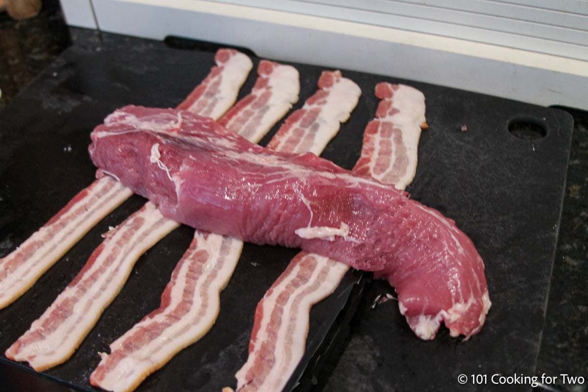 Layed out bacon with tenderloin.