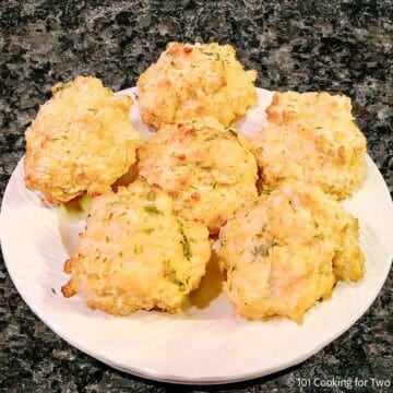 Cheddar Bay Biscuits on a plate in a pile.