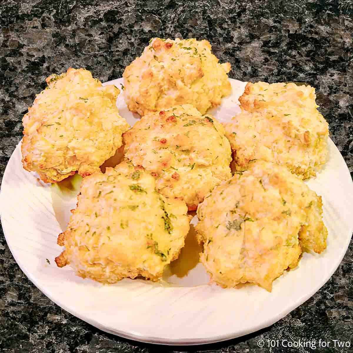 Cheddar Bay Biscuits on a plate in a pile.