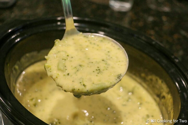 Crock pot broccoli cheese soup on a ladle.