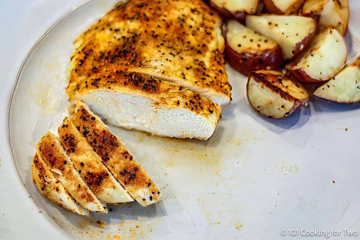 Baked chicken breast with roasted potatoes.