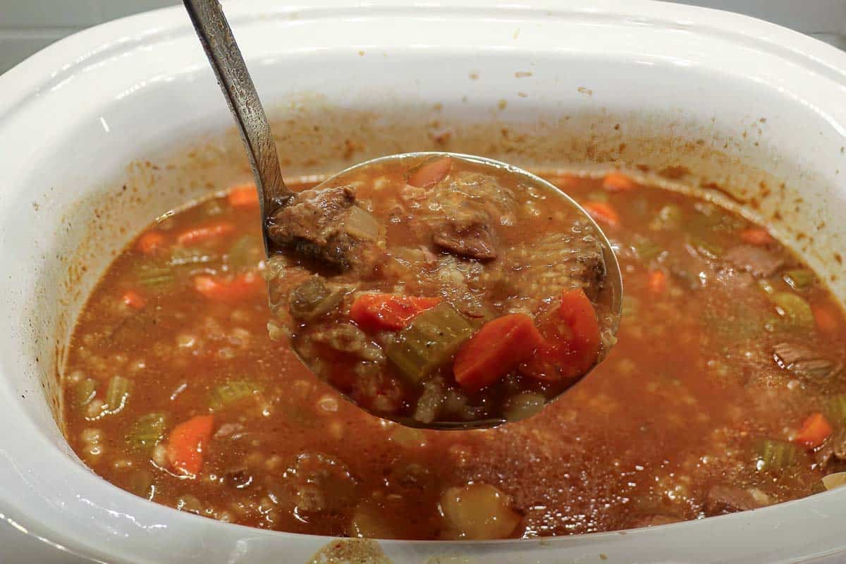 Crock pot vegetable beef soup on a ladle 2